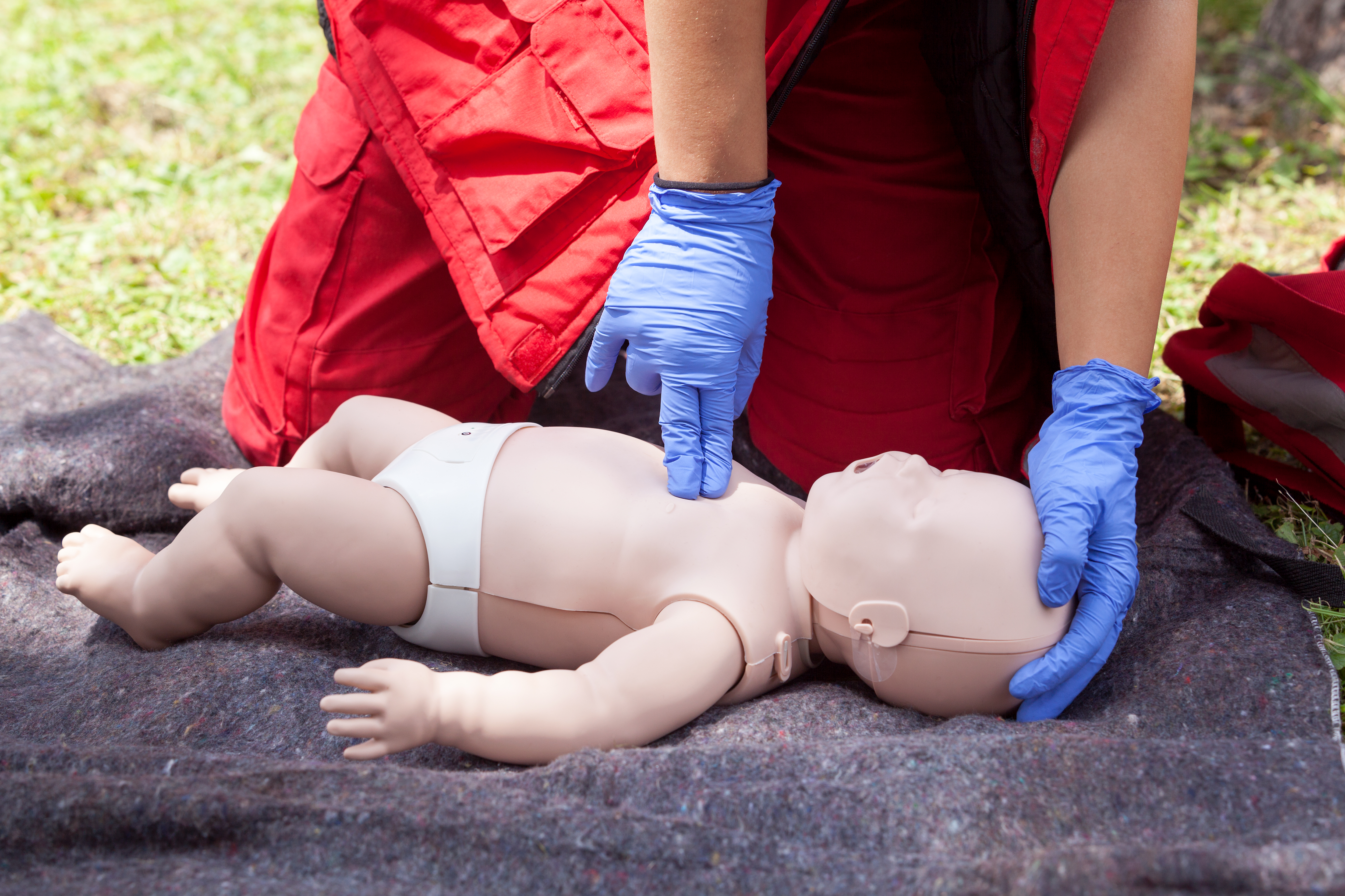 midsection-paramedic-performing-cpr-dummy