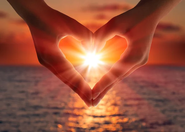 depositphotos_32107507-stock-photo-sunset-in-heart-hands